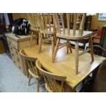A modern lightwood dining table & six pine chairs