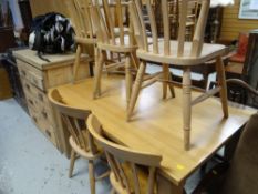 A modern lightwood dining table & six pine chairs