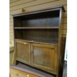 A vintage oak adjustable bookcase with cupboard below