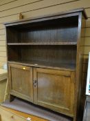 A vintage oak adjustable bookcase with cupboard below