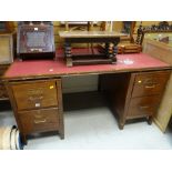 A vintage wooden office desk with two banks of two drawers