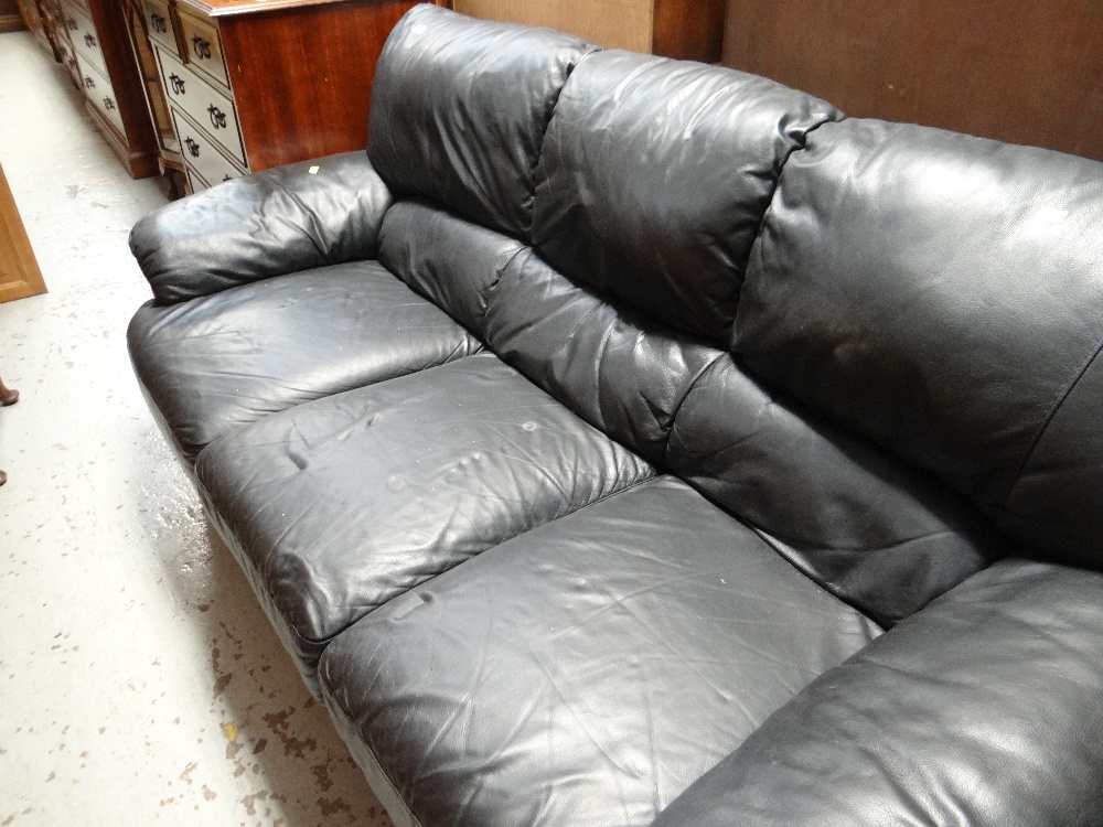 A three-seater black leather sofa