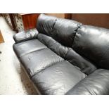 A three-seater black leather sofa