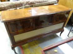 A vintage 'Hungarian Rhapsody' polished walnut record player / radiogram cabinet