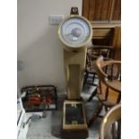 A set of large coin-operated weighing scales