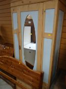 A painted single-door mirrored pine wardrobe & pine bed end