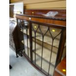 A two-door bow front railback china cabinet