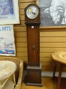 A vintage oak encased grandmother clock