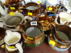 A quantity of copper lustre jugs