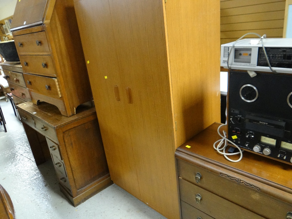 A vintage three-drawer chest, a two-door wardrobe, polished sloped front bureau