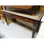 A two-drawer antique table on reeded supports (distressed)