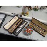 Three cased Parker pens, a floral glass paperweight etc