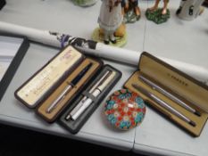 Three cased Parker pens, a floral glass paperweight etc