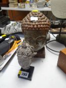 Two Buddhist head busts on stands