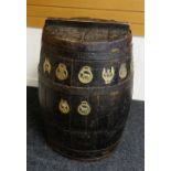 A NINETEENTH CENTURY WOODEN BEER BARREL with ironwork banding and mounted with eight old horse bras