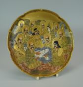 A BOXED MEIJI PERIOD SATSUMA PLATE typically decorated with multiple figures and a dragon, painted