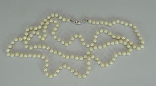 A LONG STRAND OF MIKIMOTO CULTURED PEARLS of uniform shape, approx 100-120 pearls total, white metal