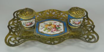 A CONTINENTAL PORCELAIN & GILT METAL DESK-STAND composed of a pair of ink-wells standing on a
