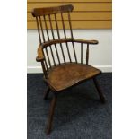 A JOINED SOLID SEAT WINDSOR-STYLE ELBOW CHAIR having splayed supports & two-stage spindle back
