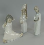 THREE LLADRO PORCELAIN FIGURES being two nightgown children and one seated as an angel