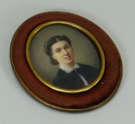 A FINE MINIATURE PORTRAIT OF A LADY probably on ivory, of oval form, the obverse inscribed with