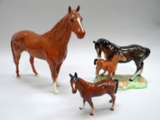 A BESWICK MODEL OF A STANDING BROWN STALLION with white front socks, painted number 95 (repaired