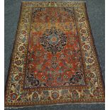 A WELL WORN RED & BLUE GROUND RUG with traditional medallion design, 207 x 137cms