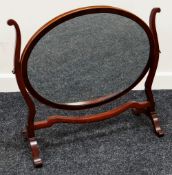 AN ANTIQUE INLAID MAHOGANY TOILET MIRROR with oval shaped glass