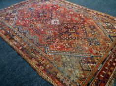 A WELL WORN RED GROUND RUG 300 x 217cms