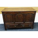 AN EARLY NINETEENTH CENTURY OAK BLANKET CHEST having a hinged lid to reveal candle box with internal