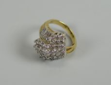 A MODERN MULTI-DIAMOND RING IN 18CT YELLOW GOLD set with many baguette and round cut diamonds in a