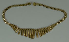 A 9CT YELLOW GOLD NECKLACE having a graduated tubular centre piece, 29.4gms