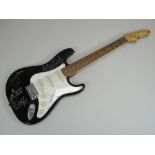 AN ELECTRIC GUITAR SIGNED BY THE BAND MEMBERS OF U2 with certificate of authenticity from '
