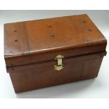 A TURN OF THE CENTURY PAINTED TIN TRUNK having a brass lock & side carry handles, 69cms wide (consi