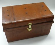 A TURN OF THE CENTURY PAINTED TIN TRUNK having a brass lock & side carry handles, 69cms wide (consi