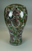 A TWENTIETH CENTURY STUDIO POTTERY VASE with colourful floral glazed body, 33cms high (consig