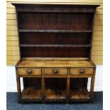 A NINETEENTH CENTURY WELSH DRESSER OF SMALL PROPORTIONS raised over an open planked platform-base,