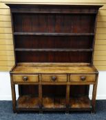 A NINETEENTH CENTURY WELSH DRESSER OF SMALL PROPORTIONS raised over an open planked platform-base,