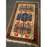 A BLUE & RED GROUND PATTERNED RUG 157 x 100cms