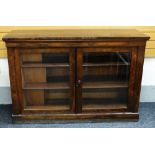 AN EARLY VICTORIAN ROSEWOOD TWO-DOOR GLAZED BOOKCASE having a hinging lid top and with a flanking '