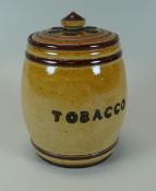 A DOULTON LAMBETH STONEWARE TOBACCO POT & COVER the body decorated with an applied green glazed sea