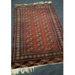 A MAROON COLOURED RUG 185 x 126cms