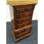 A NEAT REPRODUCTION MAHOGANY 'CHEST-ON-CHEST' composed of a base of one long & two short drawers and