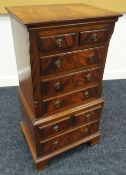 A NEAT REPRODUCTION MAHOGANY 'CHEST-ON-CHEST' composed of a base of one long & two short drawers and