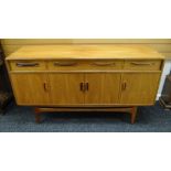 A RETRO G-PLAN RAISED SIDEBOARD with four cupboard doors, a long upper drawer flanked by two