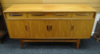 A RETRO G-PLAN RAISED SIDEBOARD with four cupboard doors, a long upper drawer flanked by two