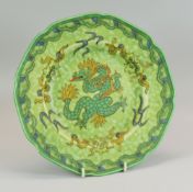 A CHARLOTTE RHEAD FOR CROWN DUCAL PLATE in mottled green ground and decorated with a stylised dragon