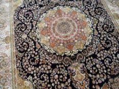 A BLUE GROUND WOVEN SILK CARPET with Shahbaz medallion design, 300 x 198cms