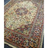 A LARGE IVORY GROUND PATTERNED RUG 330 x 250cms