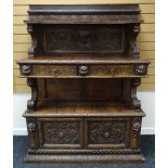 A NINETEENTH CENTURY CONTINENTAL CARVED BUFFET SIDEBOARD heavily carved with floral motifs,